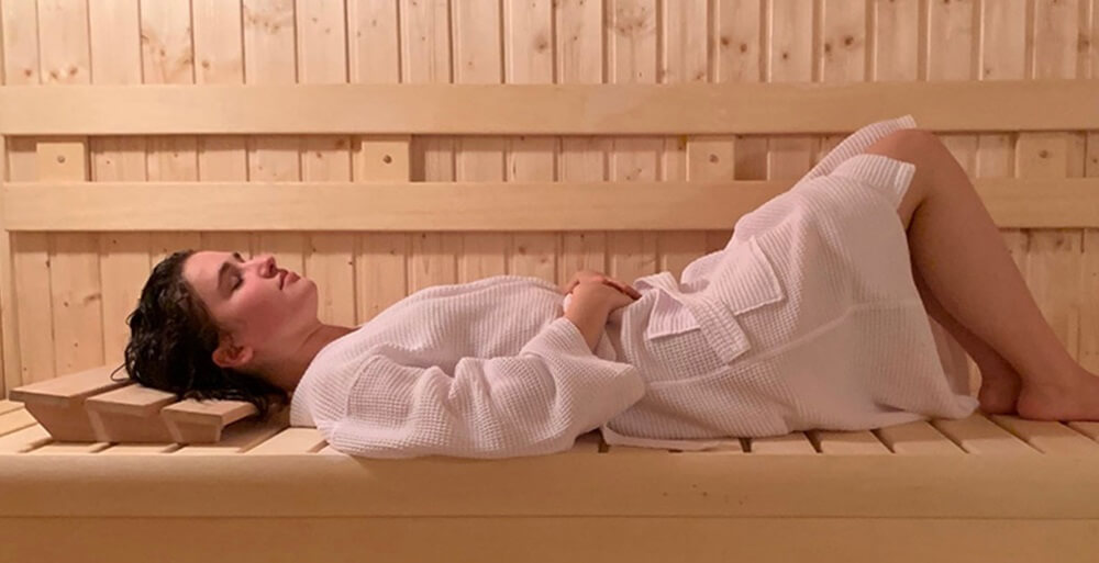 woman is relaxing in sauna