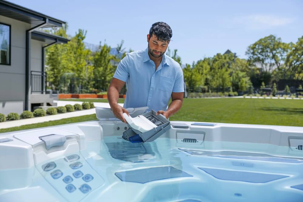 man is replacing filter in spa