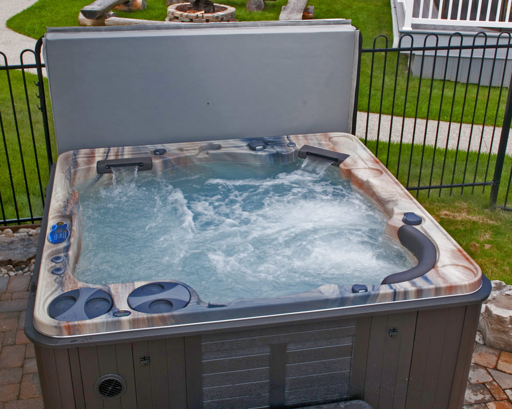 hot tub with opened cover and working jets