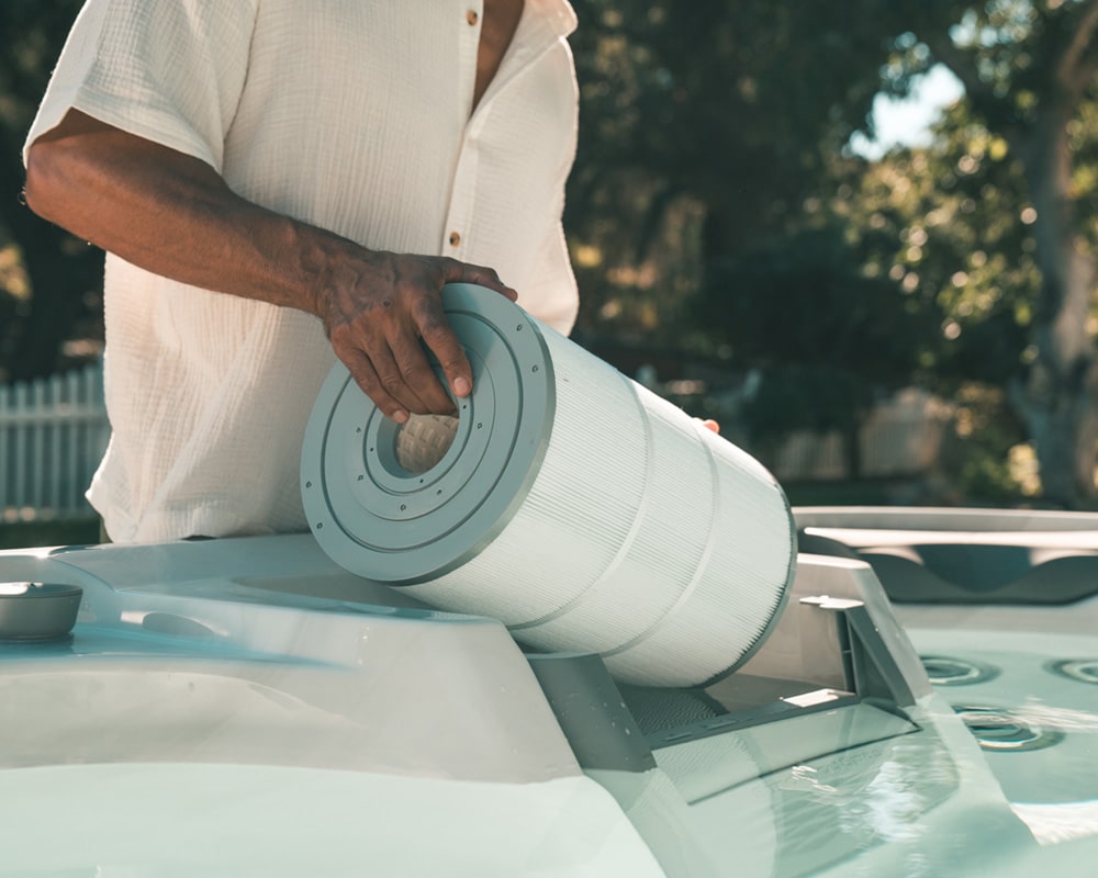 man replacing hot tub filter