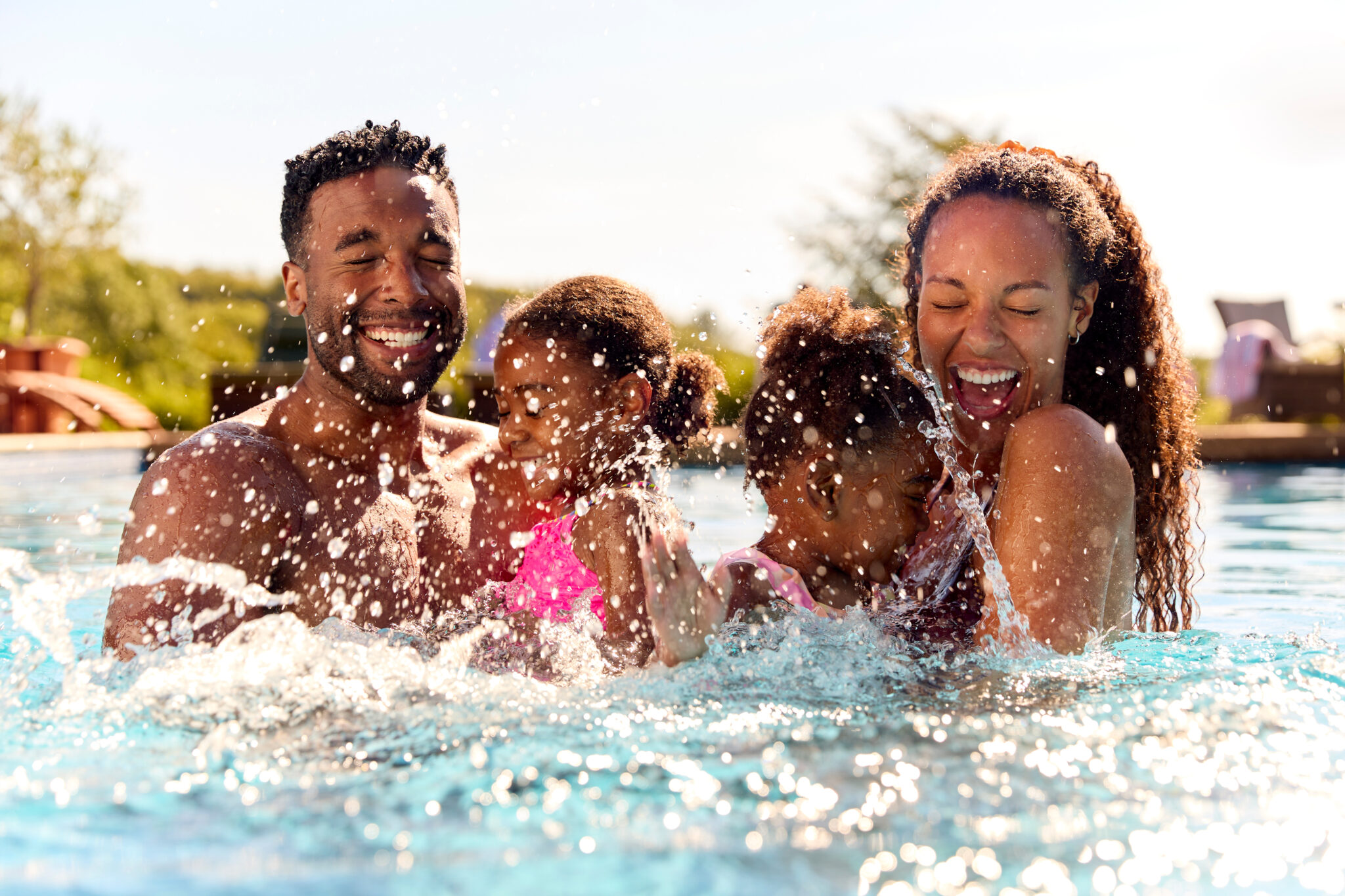 An image of a family swimming in a pool after shocking the pool.