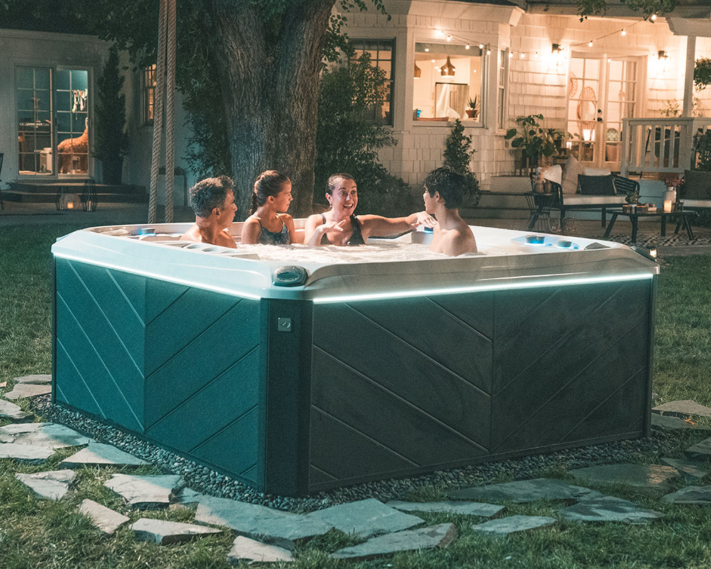 A New York family sitting in a hot tub outside their house